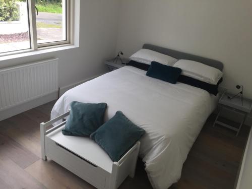 a bedroom with a white bed with two pillows on it at Carrick-on-Shannon Guest House in Carrick on Shannon