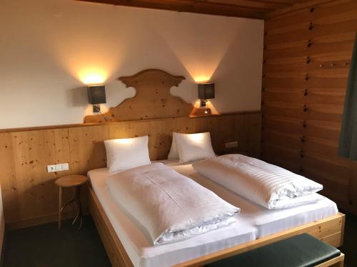 1 Schlafzimmer mit 2 Betten und Wandbeleuchtung in der Unterkunft Das Anja Sunleit`n in Filzmoos