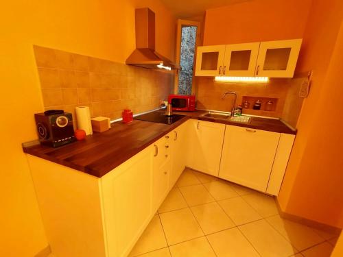 a small kitchen with a counter and a sink at Piazza Napoleone Sweet apartment in Lucca