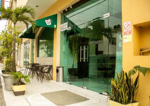 a store front with glass windows and plants outside at Hotel California in Tuxpan de Rodríguez Cano