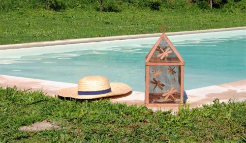 a hat and a lantern next to a swimming pool at Casa de Cerqueda in Celorico de Basto