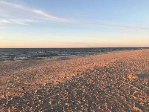 a sandy beach with the ocean in the background at Apartament Słoneczny przy plaży in Dziwnówek