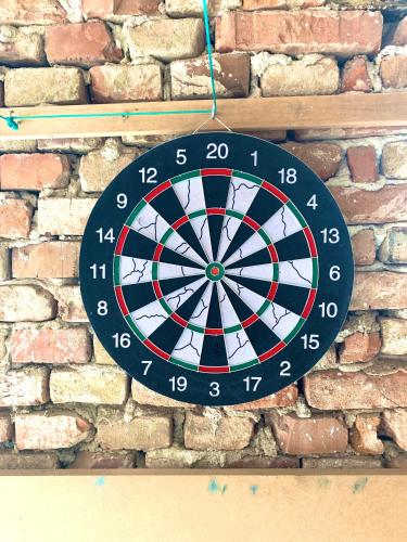 a dart board is hanging on a brick wall at Penzion Villa Verde Moravia in Klentnice