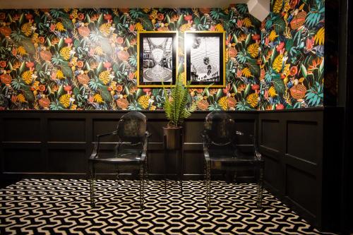 two chairs in a room with a floral wallpaper at Luxury Travel Emporium LS1 - Luxury City Centre Apartments in Leeds