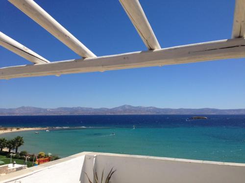 a view of the ocean from a balcony at Paros Blue Dolphin FULLY RENOVATED by RIVEA GROUP in Chrissi Akti