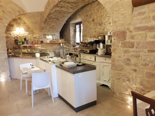 a large kitchen with a counter and a table and chairs at Suite Assisi in Assisi