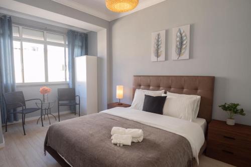 a bedroom with a large bed with a stuffed animal on it at Golden Beach Apartment in Cascais