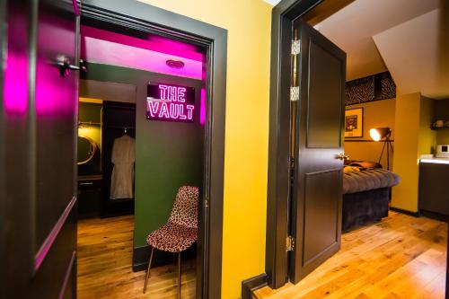 a room with a door with a sign that reads time warp vault at Luxury Travel Emporium LS1 - Luxury City Centre Apartments in Leeds