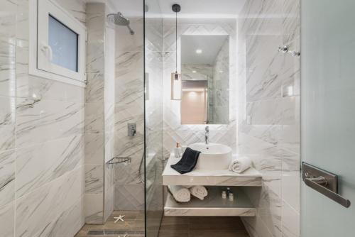 a bathroom with a sink and a shower at Margaritari Apartments in Zakynthos