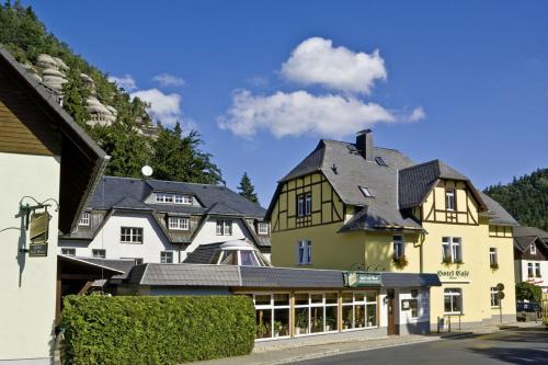 a large yellow building with a black roof at Land-gut-Hotel Cafe Meier in Kurort Oybin