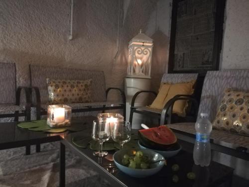 a table with candles and a bowl of fruit on it at Blue House Varenna in Varenna