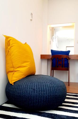 a yellow pillow sitting on top of a blue bean bag chair at Kenting Chingshan Inn in Kenting