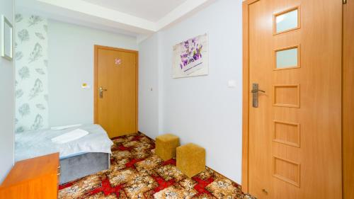 a bedroom with a bed and a wooden door at Leśniczówka pod Śnieżką in Bukowiec