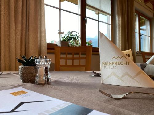 a table with a kyrmont hotel sign on top of it at Eisbacherhof in Schladming