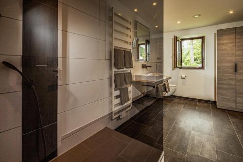 ein Bad mit einem Waschbecken und einem Spiegel in der Unterkunft Ferienwohnungen am Gablerhof in Bad Reichenhall