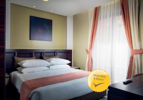 a bedroom with a large bed and a window at TIME Dammam Residence in Dammam