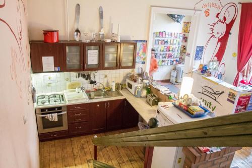 a kitchen with a sink and a stove at Unity Hostel Budapest in Budapest