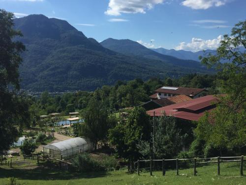 a view of a farm with mountains in the background at Agriturismo Il Balcone sulla Valle in Bedero Valcuvia