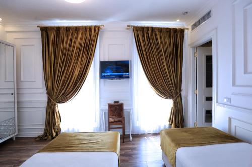 Una cama o camas en una habitación de Eler Hotel
