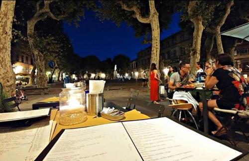 a group of people sitting at an outdoor table at Piazza Napoleone Sweet apartment in Lucca