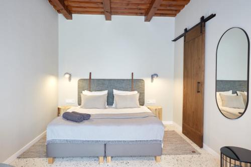 a bedroom with a large bed and a mirror at Veranda in Villány