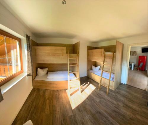 a room with two bunk beds and a window at Bergquell Tirol in Jungholz