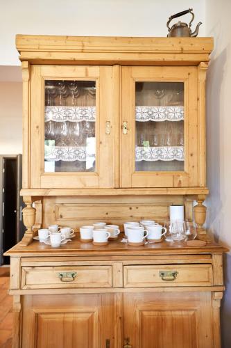 een houten hok met kopjes en schalen erop bij Veranda in Villány