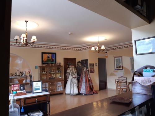 two people in wedding dresses in a living room at Hotel Mayno in Pastrana