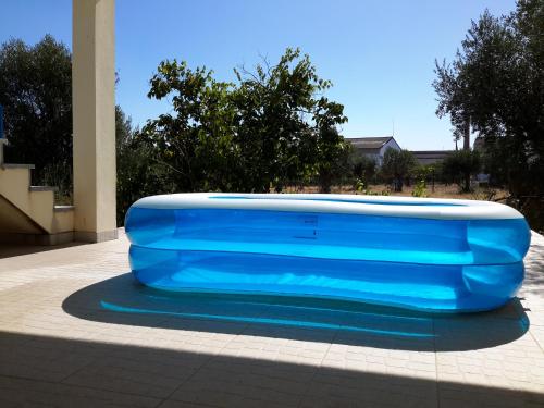 a large blue object is sitting on a sidewalk at Villa Ortiga in Mação