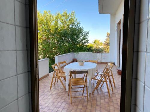 a patio with a table and chairs on a patio at Vista Mare a 300 mt dalla spiaggia in Cariati