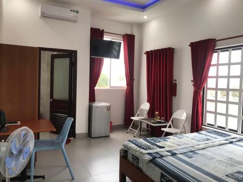a bedroom with a bed and a table and chairs at Tam Homestay in Da Nang