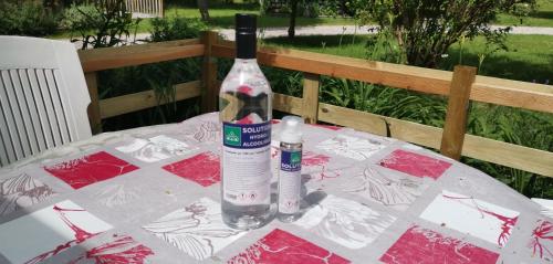 a bottle of wine sitting on top of a table at Gîtes Les Grandes Voies - Clé Vacances in Le Ménil