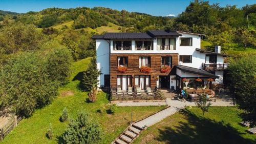 an aerial view of a house on a hill at Talhaus in Vişeu de Sus