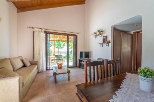 a living room with a couch and a table at Kerithra Villa in Vasiliki