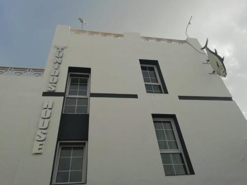 a white building with a shark on the side of it at Apartamentos Empul " Tunidos House " in Barbate