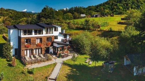 an aerial view of a house in a field at Talhaus in Vişeu de Sus