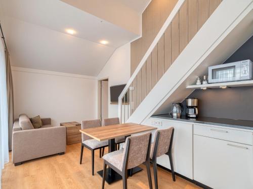 a kitchen and dining room with a table and chairs at WESTSIDE Hotel in Munich