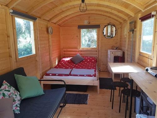 a small room with a bed and a table at Quinta Portugo in Cernache do Bonjardim