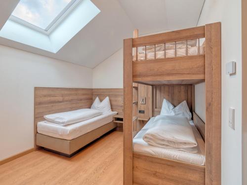 two bunk beds in a room with a skylight at WESTSIDE Hotel in Munich
