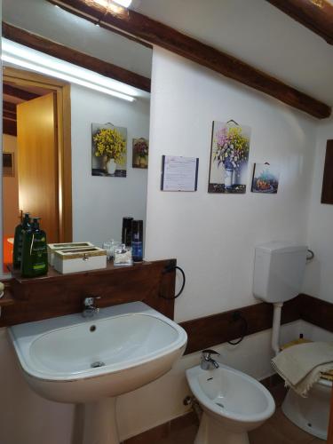 a bathroom with a white sink and a toilet at B&B Villa San Marco in Agrigento