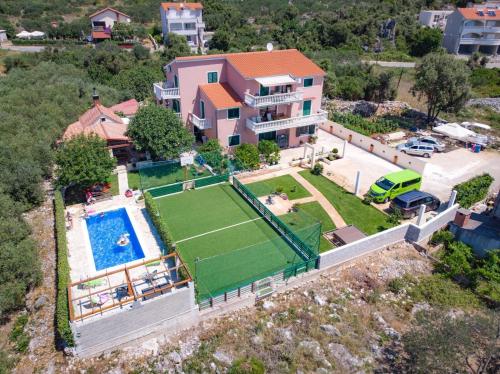 an aerial view of a house with a tennis court at Apartments Mirko in Seget Vranjica