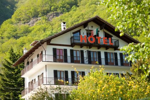 a hotel building with a sign on top of it at Hotel Palavas in Villar Pellice