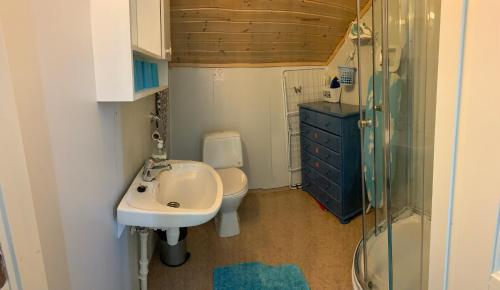 a small bathroom with a sink and a toilet at Sentralen inn in Andenes