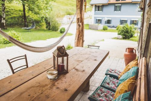 a wooden table with a lantern on top of it at Chalet am Sonnenhang in Obertraun