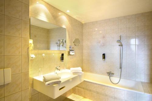 a bathroom with a sink and a shower at Hotel Alexandra in Plauen