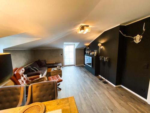 a living room with a couch and a table at Boutique Apartment Anne in Bad Harzburg