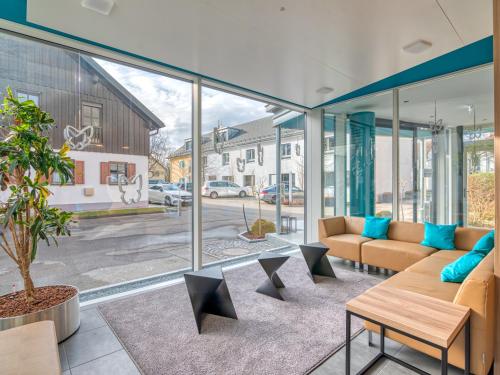 a living room with a couch and a table at WESTSIDE Hotel in Munich