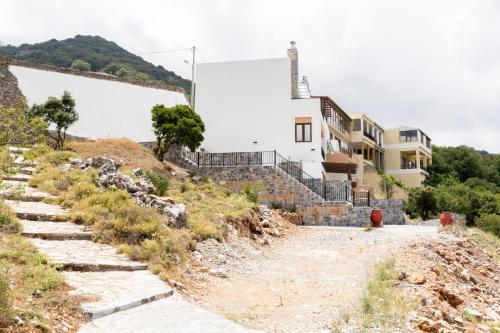 a dirt road leading up to a building on a hill at Dictamus Homes in Magoulás