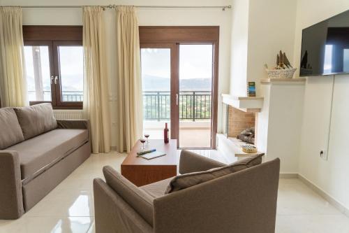a living room with a couch and a table at Dictamus Homes in Magoulás