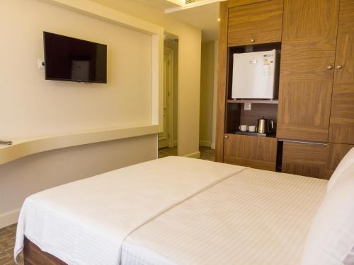 Ένα ή περισσότερα κρεβάτια σε δωμάτιο στο Bursa Ulupark Hotel